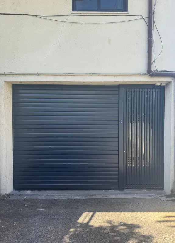 Anthracite roller door with slatted pedestrian gate