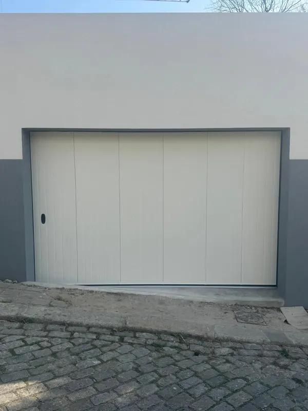 White side-sliding sectional door at a house