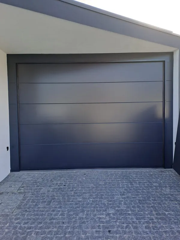 Anthracite sectional door at a house entrance
