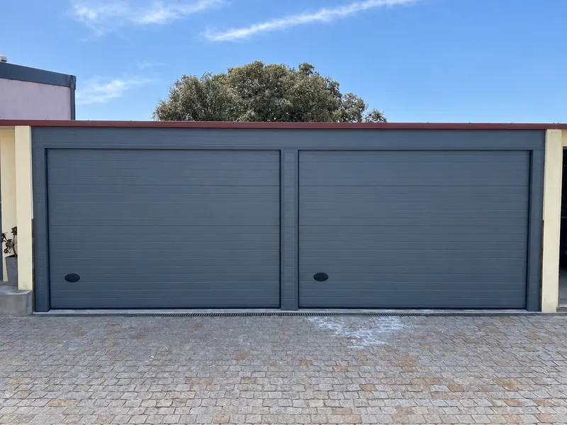 Two grey sectional doors on a double garage