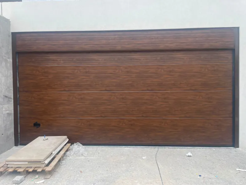 Wide wood-effect sectional door on site